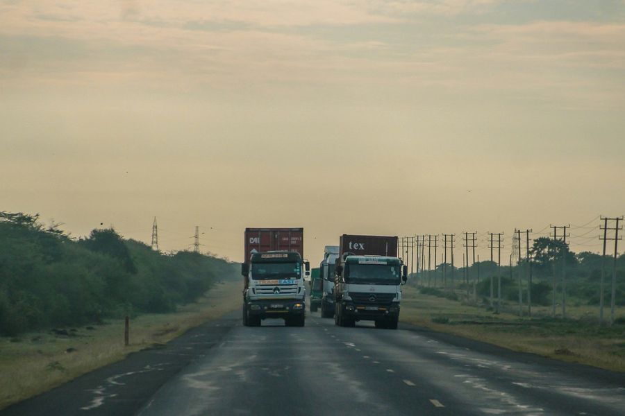 Trucks driving along a highway in Kenya